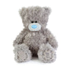 Gray teddy bear with a blue nose on a white background