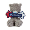Plush teddy bear holding a sign that says 'No. 1 Grandad' on a white background
