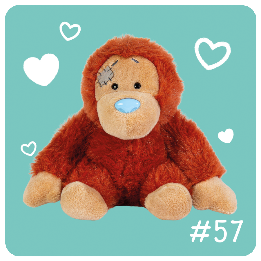 Plush monkey toy with a bandage on a teal background with heart shapes