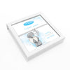 A silver beaded bracelet with a feather charm, presented in a white square gift box. The box lid features a printed illustration of a teddy bear holding a heart, with blue and gray text including 'Me to You' and 'Feathers appear'.