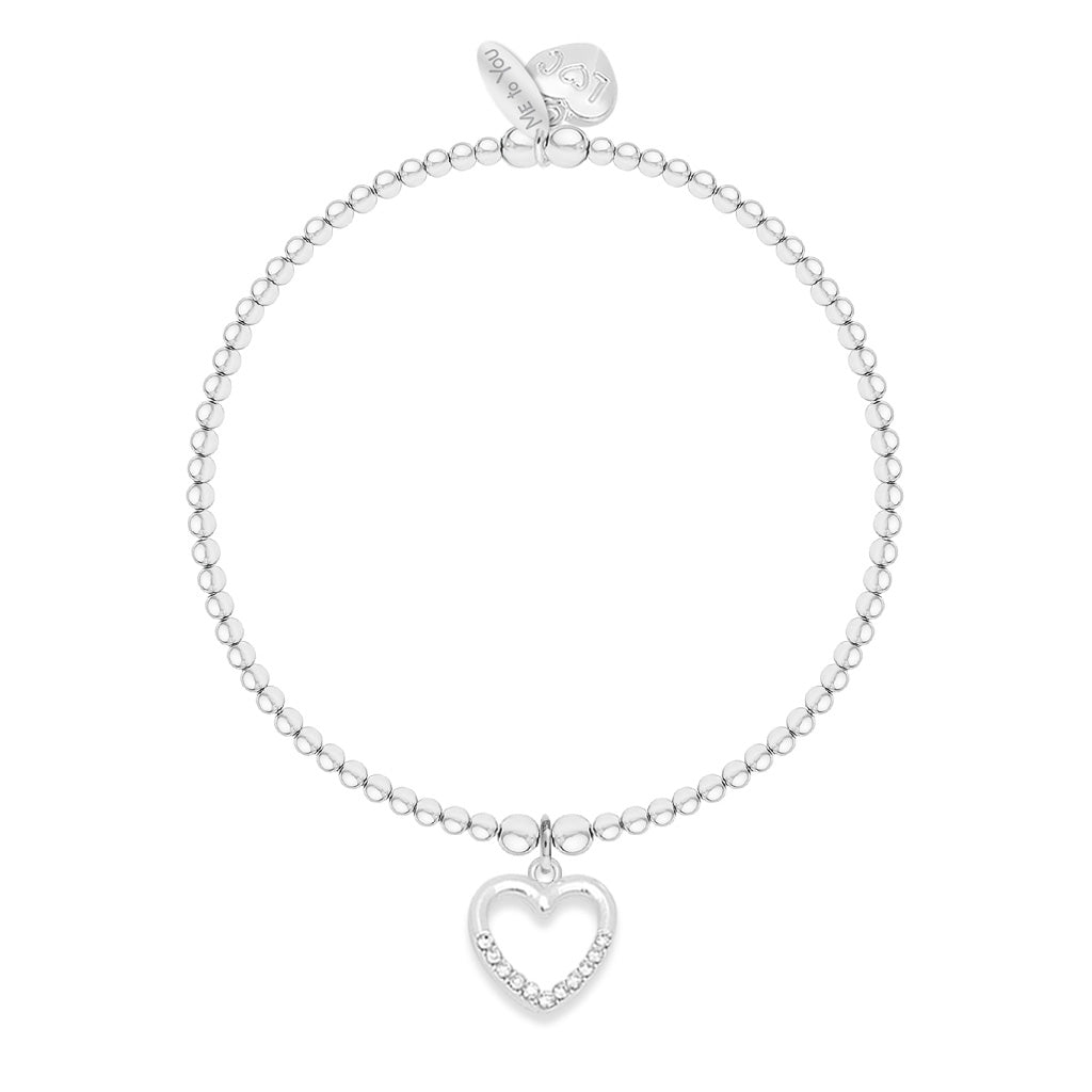A silver beaded bracelet with a dangling open heart charm set with small clear stones, shown on a plain white background.
