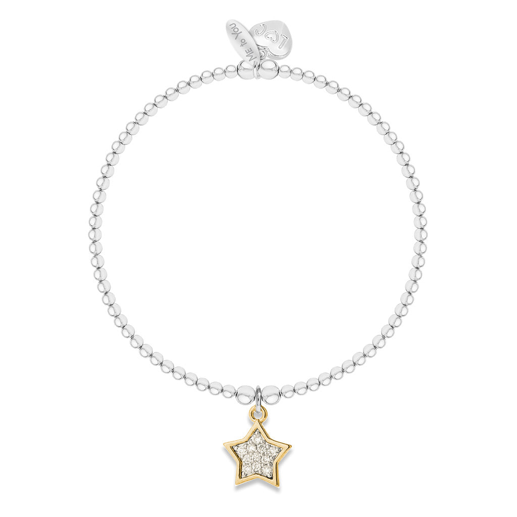 A delicate silver beaded bracelet with a gold star charm set with small clear stones, displayed on a clean white background.