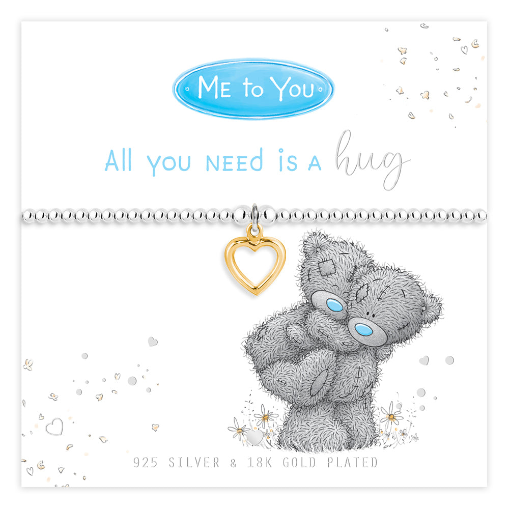 Silver bracelet with gold heart charm and Me to You bear on a white background