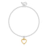 A delicate silver beaded bracelet with a small gold heart-shaped charm, displayed on a clean white background.
