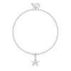A silver beaded bracelet with a dangling star charm set with a small clear crystal, shown on a plain white background.