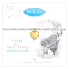 A silver-toned bracelet with a gold heart-shaped charm, displayed on a white card that reads 'Happy wedding anniversary' and 'Me to You'. The card also features a gray teddy bear illustration with blue eyes and text stating '925 Silver & 18K Gold Plated'.