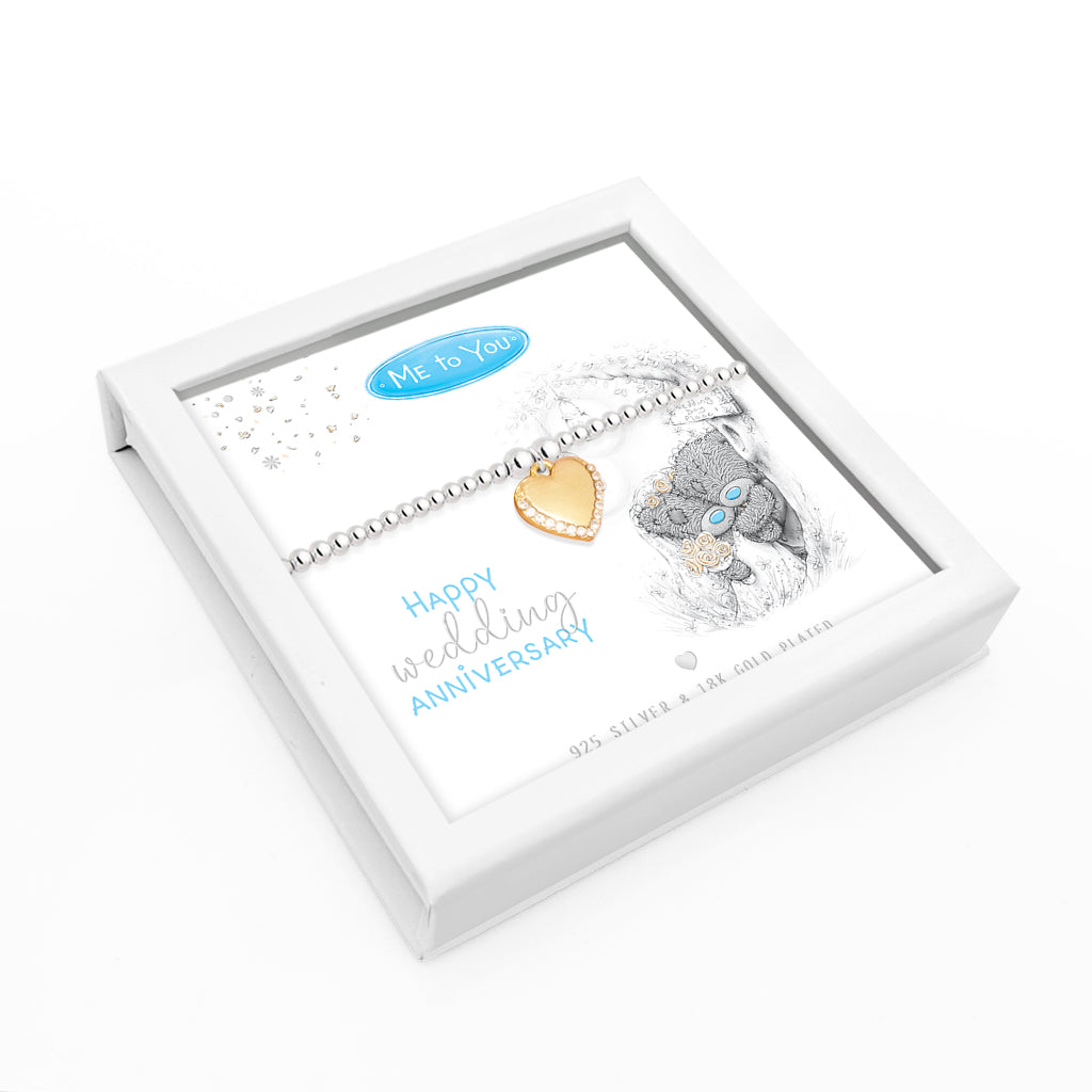 A silver and gold wedding anniversary bracelet presented in a white gift box with a printed insert featuring a teddy bear and the text 'Happy wedding Anniversary' and 'Me to You'.
