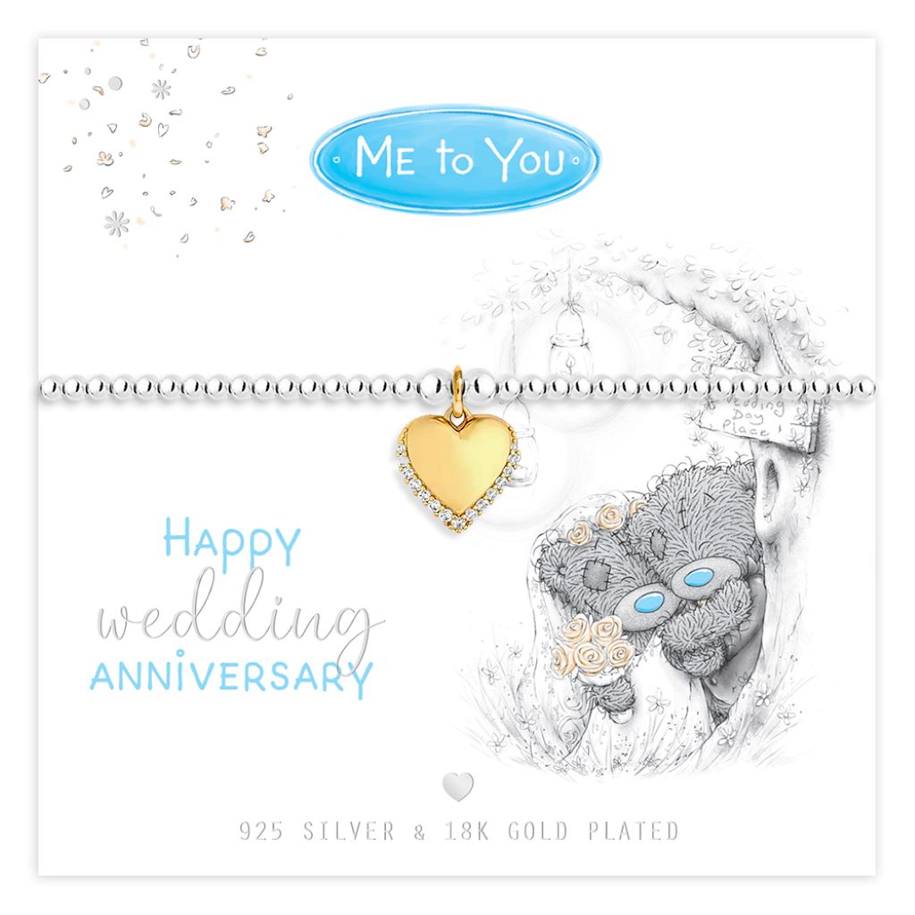A silver-toned bracelet with a gold heart-shaped charm, displayed on a white card that reads 'Happy wedding anniversary' and 'Me to You'. The card also features a gray teddy bear illustration with blue eyes and text stating '925 Silver & 18K Gold Plated'.