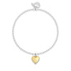 A silver beaded bracelet with a small gold heart charm outlined with clear stones, displayed on a clean white background.