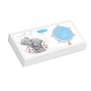 A white gift box featuring a Me To You teddy bear illustration and a round blue charm with gold heart accents, photographed on a clean white background.
