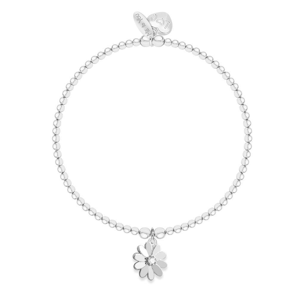 A silver beaded bracelet with a small flower charm featuring a clear central stone, displayed on a clean white background.
