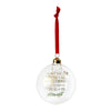A clear glass Christmas ornament ball with a red hanging ribbon, gold cap, and printed message in gold lettering with small green and red floral accents, shown on a plain white background.