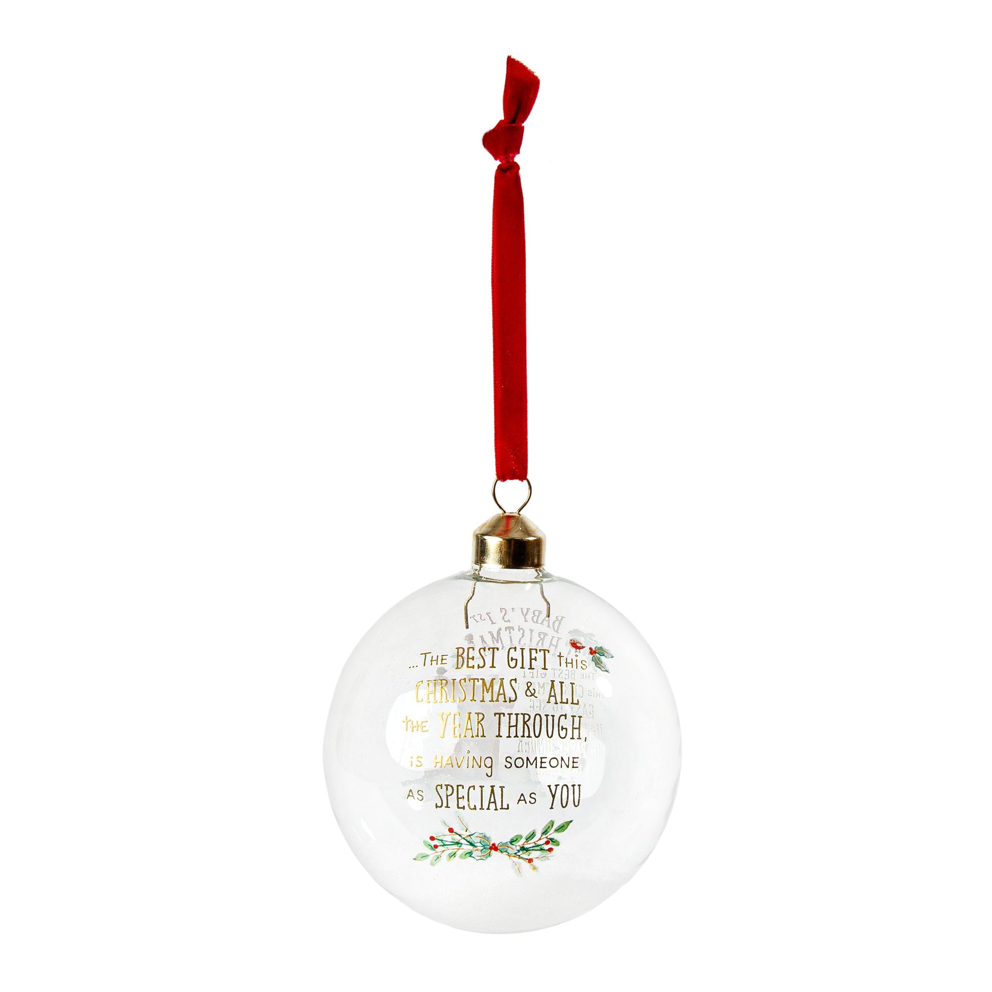 A clear glass Christmas ornament ball with a red hanging ribbon, gold cap, and printed message in gold lettering with small green and red floral accents, shown on a plain white background.